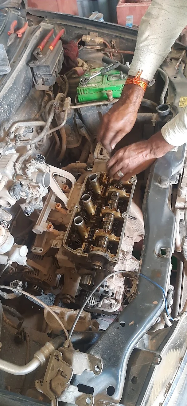 Mechanic working on a car engine at our Patna workshop